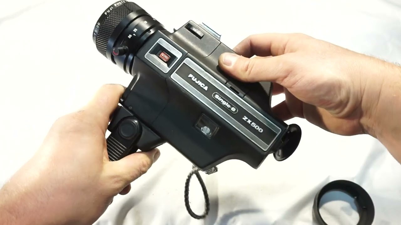 Fujica ZX500 loading Super 8 film and batteries on Super 8 camera