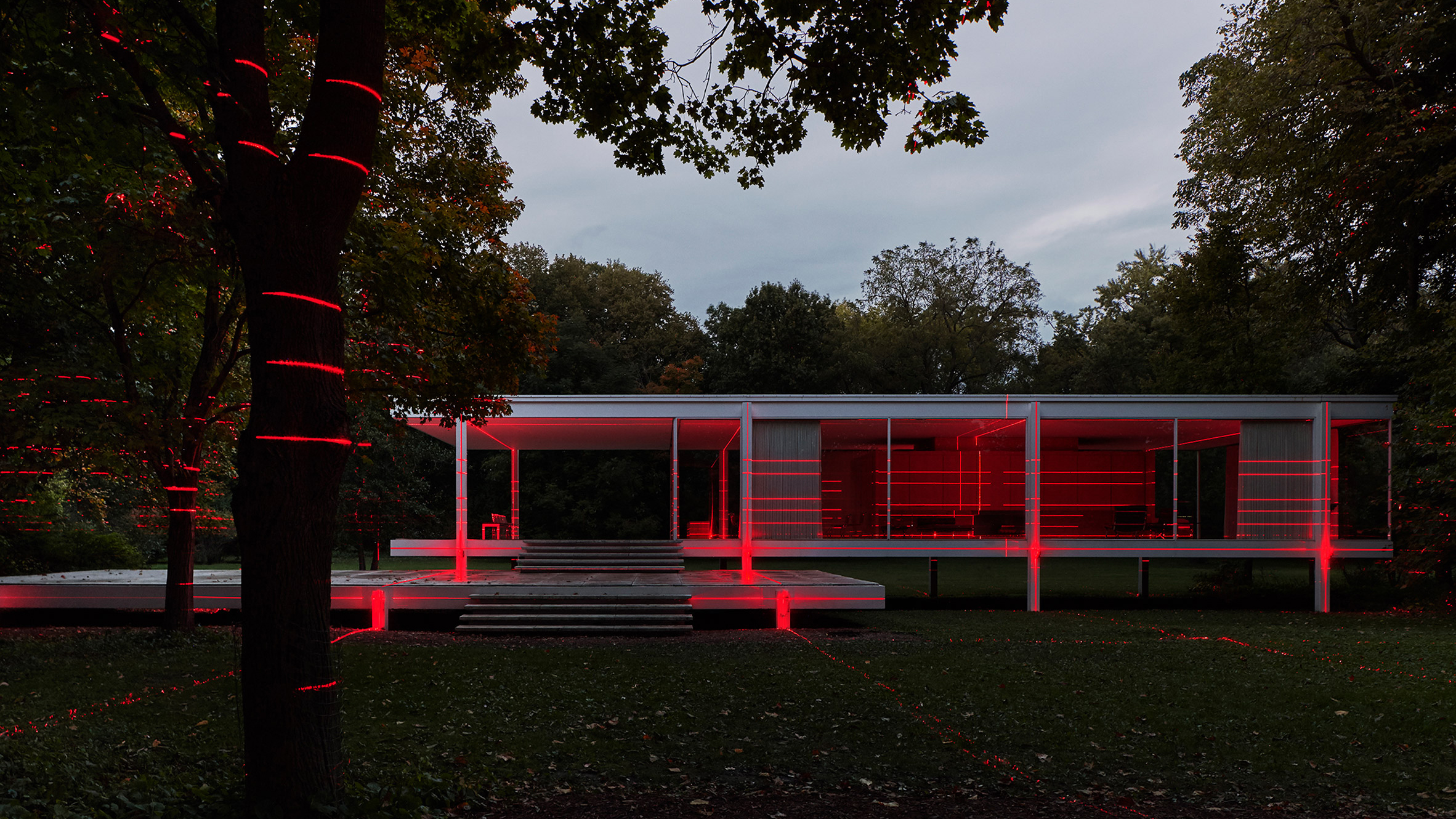 Mies van der Rohe's Farnsworth House illuminated with red lasers