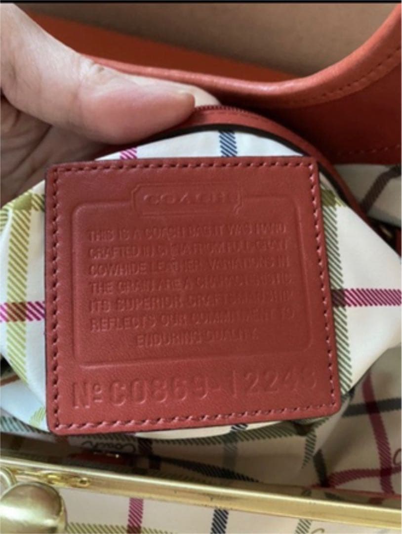 コーチ オレンジ エルゴレザープリーテッドフレームドサッチェルの通販